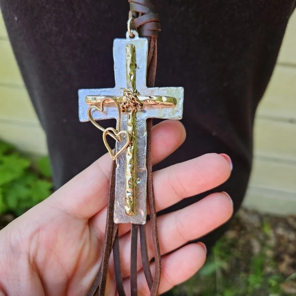 brown leather cord necklace with oversized silver and gold tone cross pendant